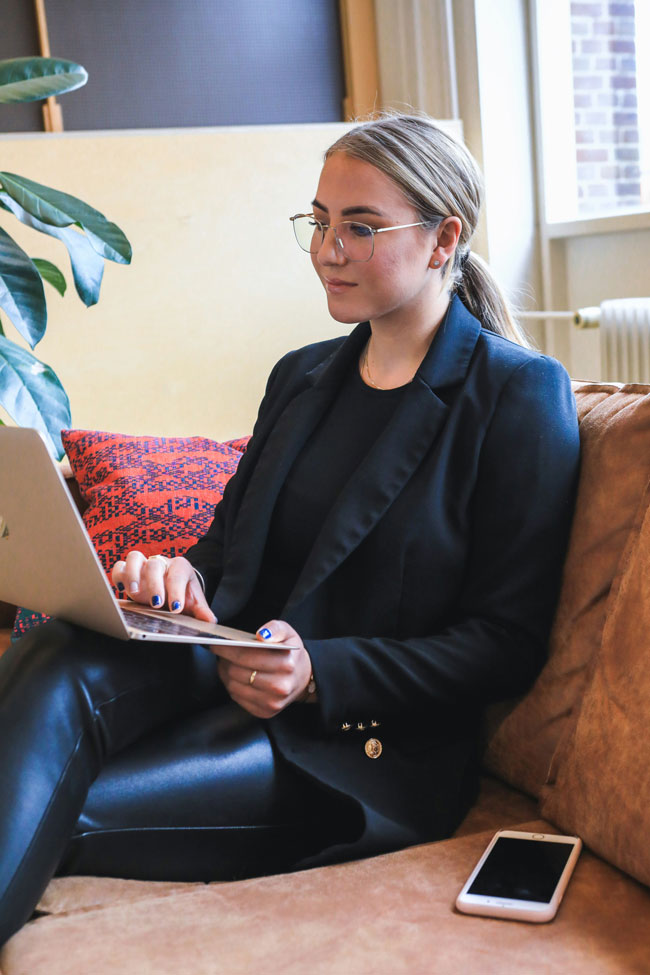 Woman on couch using computer